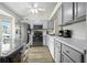 Modern kitchen featuring stainless steel appliances, white cabinetry, and breakfast nook at 3280 Villa Way Cir, St Cloud, FL 34769