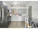 Kitchen with stainless steel appliances, white cabinetry, breakfast nook, and modern fixtures at 3280 Villa Way Cir, St Cloud, FL 34769