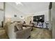 Cozy living room featuring a comfortable sofa, ceiling fan, and a large screen television at 3280 Villa Way Cir, St Cloud, FL 34769