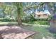 Spacious backyard featuring mature trees, brick patio, and lush landscaping providing privacy at 3519 Gatlin Place Cir, Orlando, FL 32812
