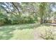 Expansive backyard featuring mature trees providing ample shade and greenery for a tranquil setting at 3519 Gatlin Place Cir, Orlando, FL 32812