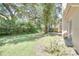 Lush backyard showcasing mature trees and green lawn space, perfect for outdoor activities and relaxation at 3519 Gatlin Place Cir, Orlando, FL 32812