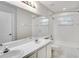Bright bathroom has white vanity with double sinks, a large mirror and shower/tub combination at 3519 Gatlin Place Cir, Orlando, FL 32812