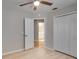 Bright bedroom features light-colored wood floors, neutral walls, a ceiling fan, closet, and ensuite bathroom at 3519 Gatlin Place Cir, Orlando, FL 32812