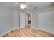 Bright bedroom features light-colored wood floors, neutral walls, a ceiling fan and closet at 3519 Gatlin Place Cir, Orlando, FL 32812