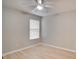 This bedroom has neutral walls, light-colored wood floors, ceiling fan, and window with white blinds at 3519 Gatlin Place Cir, Orlando, FL 32812