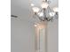 An elegant chandelier and hallway entrance to the bathroom at 3519 Gatlin Place Cir, Orlando, FL 32812