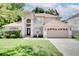 Charming two-story home featuring a well-maintained lawn and a two-car garage at 3519 Gatlin Place Cir, Orlando, FL 32812