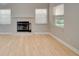 Brightly lit living room features a traditional fireplace, modern lighting and expansive hardwood flooring at 3519 Gatlin Place Cir, Orlando, FL 32812