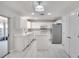 Bright kitchen with white cabinets, tile floors, an island, and stainless steel appliances at 3519 Gatlin Place Cir, Orlando, FL 32812