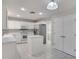 Bright kitchen with white cabinets, stainless steel appliances and central island at 3519 Gatlin Place Cir, Orlando, FL 32812