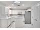 Bright kitchen featuring tile floors, an island, white cabinets, and stainless steel appliances at 3519 Gatlin Place Cir, Orlando, FL 32812