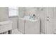 Bright laundry room with washer, dryer, utility sink and wire shelving at 3519 Gatlin Place Cir, Orlando, FL 32812