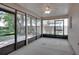Screened patio with ceiling fan and views of fenced backyard at 3519 Gatlin Place Cir, Orlando, FL 32812