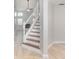 Elegant staircase with wood steps and white railings, leading to the upper level at 3519 Gatlin Place Cir, Orlando, FL 32812