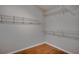 Walk-in closet with built-in wire shelving and hardwood flooring at 3519 Gatlin Place Cir, Orlando, FL 32812