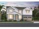 Charming two-story home with a covered porch and a two-car garage, showcasing a blend of modern and traditional design at 426 Veneto Cir, Clermont, FL 34715