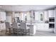 Modern kitchen featuring white cabinetry, stainless steel appliances, an island with seating, and stylish pendant lighting at 426 Veneto Cir, Clermont, FL 34715
