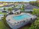 Aerial view of community pool with lounge chairs, cabana, and surrounding residential area at 4316 Foggy Oak Ln, Sanford, FL 32773