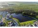 Scenic aerial view of the community featuring a pond, lush greenery, and well-maintained homes at 4316 Foggy Oak Ln, Sanford, FL 32773