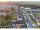 Scenic aerial view of the neighborhood with neat streets, lush greenery, and a serene lake in the distance at 4316 Foggy Oak Ln, Sanford, FL 32773