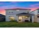 Two-story home with a covered patio, sliding glass doors, and a green lawn at 4316 Foggy Oak Ln, Sanford, FL 32773