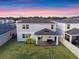 Spacious backyard with a covered patio, lush lawn, and a white fence, perfect for outdoor entertaining at 4316 Foggy Oak Ln, Sanford, FL 32773