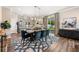 Elegant dining area with stylish lighting, seating for six, and view into the modern kitchen at 4316 Foggy Oak Ln, Sanford, FL 32773