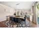 Bright dining room featuring stylish chairs, modern lighting, and open access to the contemporary kitchen at 4316 Foggy Oak Ln, Sanford, FL 32773