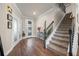 Inviting foyer with staircase, wooden floors, elegant decor, and plenty of natural light at 4316 Foggy Oak Ln, Sanford, FL 32773