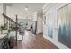 Bright foyer with wood floors, staircase, and frosted glass doors leading to other rooms in the home at 4316 Foggy Oak Ln, Sanford, FL 32773