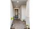 Inviting front porch featuring a blue door, brick flooring, and potted plants for a warm welcome at 4316 Foggy Oak Ln, Sanford, FL 32773