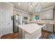 Bright kitchen showcasing stainless steel appliances, center island, and stylish gray cabinetry at 4316 Foggy Oak Ln, Sanford, FL 32773