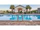 Outdoor community pool with a gated entrance, lounge chairs, and palm tree landscaping at 4316 Foggy Oak Ln, Sanford, FL 32773