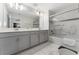 Modern bathroom features double vanity, shower-tub combo, and marble floors at 4974 Windermere Ave, Kissimmee, FL 34746