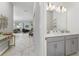 Bathroom featuring double sinks, gray cabinets, and a modern mirror, all in a brightly lit and stylish space at 4974 Windermere Ave, Kissimmee, FL 34746