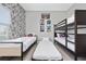 Bedroom showcasing twin beds and a bunk bed, designed with comic book themed wallpaper at 4974 Windermere Ave, Kissimmee, FL 34746