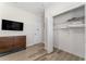 Bedroom view with dresser and closet access, TV and wooden floors at 4974 Windermere Ave, Kissimmee, FL 34746