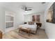 Bright bedroom with light wood floors, king bed and ensuite bathroom at 4974 Windermere Ave, Kissimmee, FL 34746