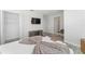 Cozy bedroom featuring walk-in closet, TV, and light wood floors at 4974 Windermere Ave, Kissimmee, FL 34746