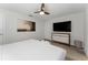Comfortable bedroom featuring a large TV and light wood floors at 4974 Windermere Ave, Kissimmee, FL 34746
