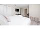 Bright bedroom with white bedding, television, and modern decor, perfect for relaxation at 4974 Windermere Ave, Kissimmee, FL 34746