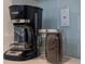 The coffee bar shows off a great appliance with some additional canisters; everything is ready to brew a pot! at 4974 Windermere Ave, Kissimmee, FL 34746