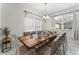 Large dining table with seating for ten, decorated with blue dishware and a modern chandelier at 4974 Windermere Ave, Kissimmee, FL 34746
