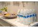 Entryway table with several bottles of water, snacks, and a basket offer a practical and welcoming space at 4974 Windermere Ave, Kissimmee, FL 34746