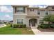 Charming townhome with a well-manicured lawn and inviting front entrance, perfect for a growing Gathering at 4974 Windermere Ave, Kissimmee, FL 34746
