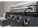 Outdoor grill with control knobs, offering precise temperature control for perfect barbecue at 4974 Windermere Ave, Kissimmee, FL 34746
