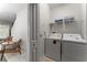 Bright laundry room featuring a white washer and dryer and storage shelves at 4974 Windermere Ave, Kissimmee, FL 34746