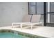 Poolside with modern lounge chairs, offering a relaxing outdoor space for sunny days at 4974 Windermere Ave, Kissimmee, FL 34746