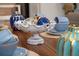 Dining room table centerpiece, a white bowl filled with decorative orbs; elegant dining set for formal meals at 4974 Windermere Ave, Kissimmee, FL 34746